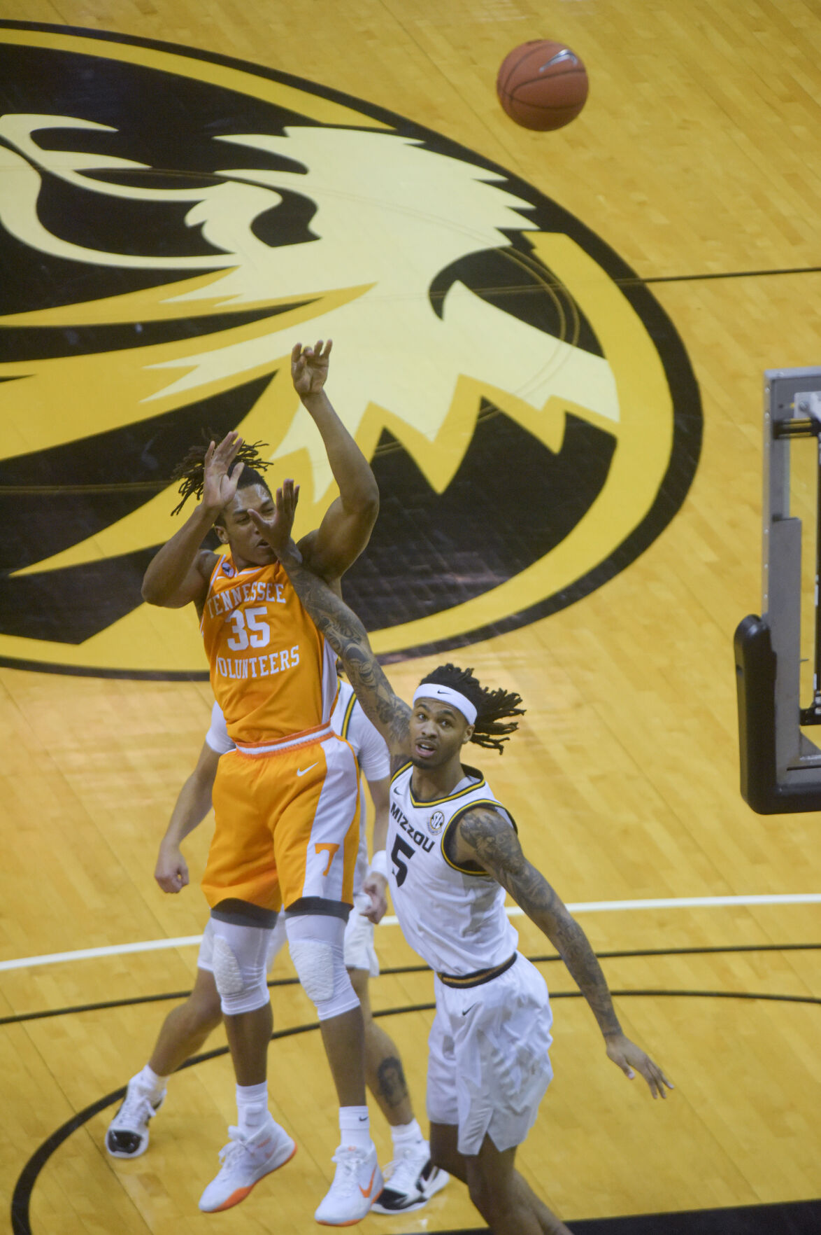 From left, Tennessee's Yves Pons shoots past Missouri forward Mitchell Smith's attempted block